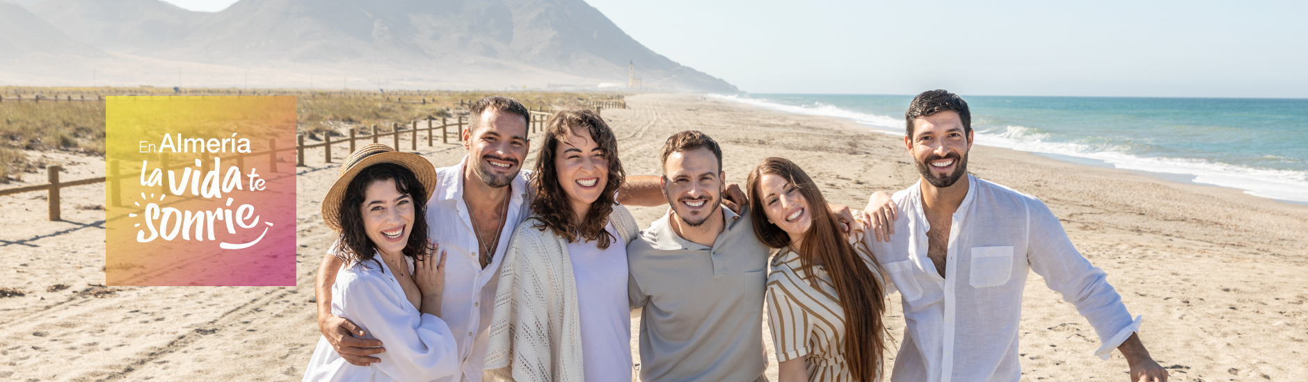 Texto Almería, la vida te sonríe, acompañado de la foto de un grupo de personas en la playa