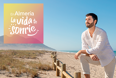 Campaña En Almería la vida te sonríe, con la foto de un chico apoyado en una valla en la orilla de la playa mirando al horizonte